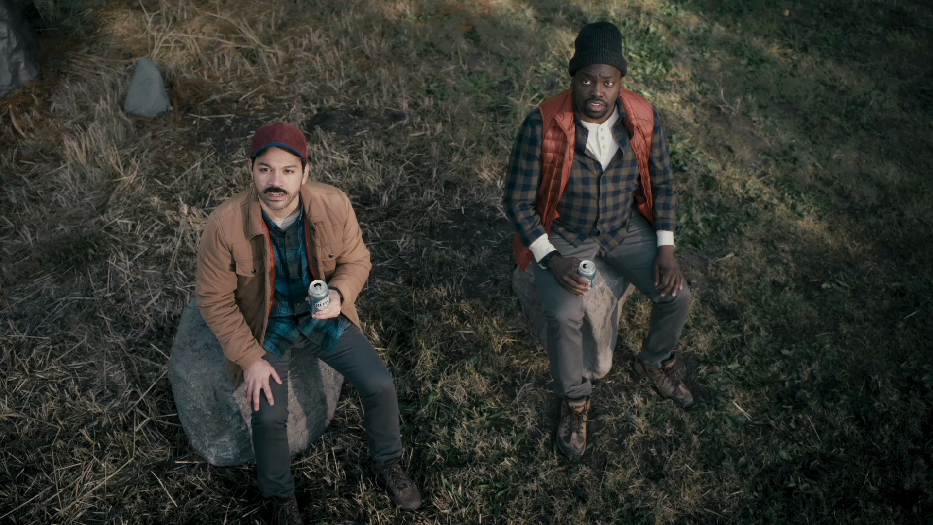 The two hikers look up in surprise at the voices above the mountains